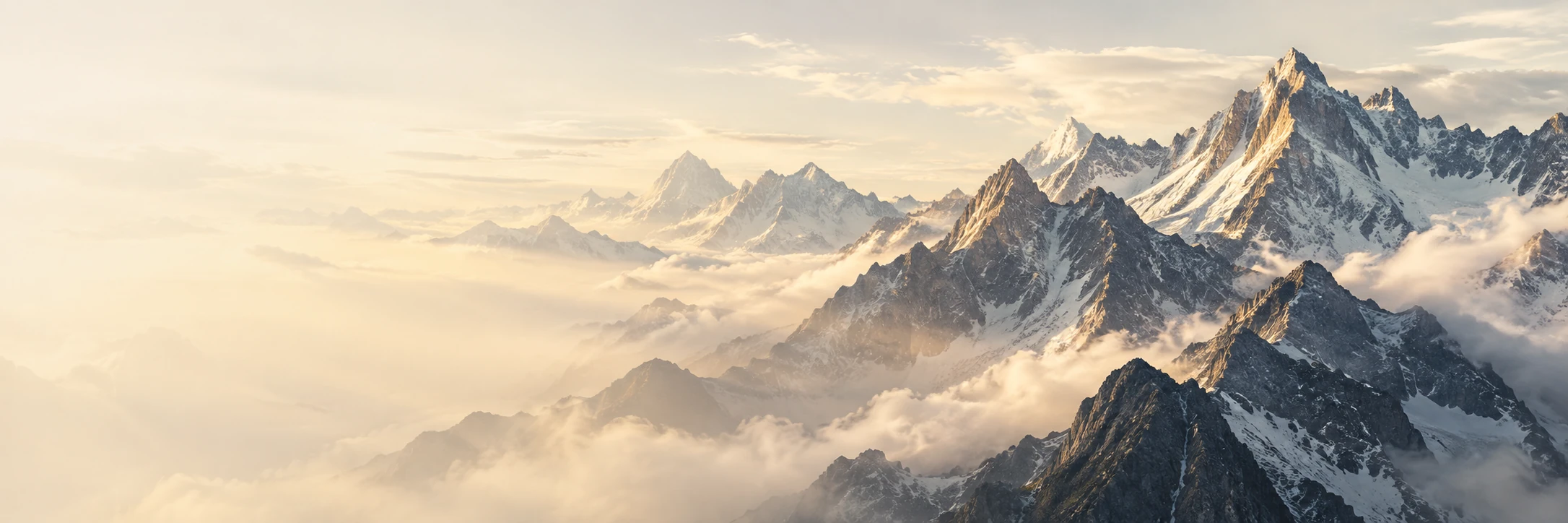 A mountain ridge rising through mist